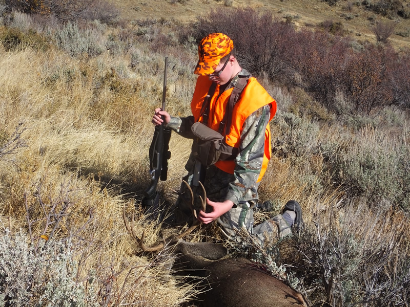 Landen admiring his first four point buck.